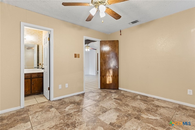 2013 Moonlight Dr, Killeen, TX 76543 - unfurnished bedroom featuring ceiling fan, connected bathroom, and a textured ceiling