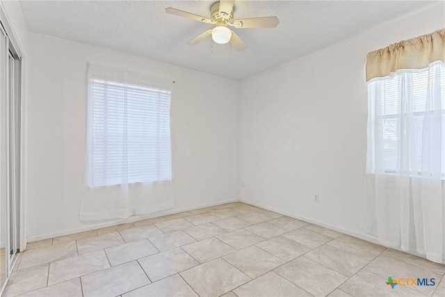 2013 Moonlight Dr, Killeen, TX 76543 - tiled spare room featuring ceiling fan, plenty of natural light, and a textured ceiling