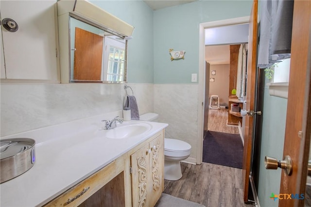 bathroom featuring vanity, wood finished floors, and toilet