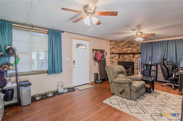 living area featuring ceiling fan, wood finished floors, and visible vents
