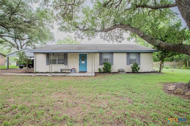 ranch-style home featuring a porch, brick siding, and a front yard