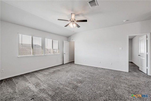 carpeted empty room featuring visible vents, ceiling fan, baseboards, and vaulted ceiling