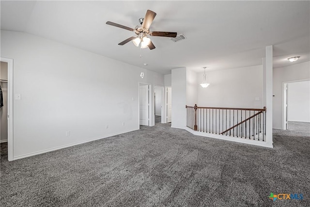 carpeted spare room with a ceiling fan, visible vents, and baseboards