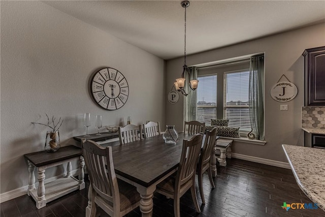 dining room featuring dark hardwood / wood-style flooring and a chandelier