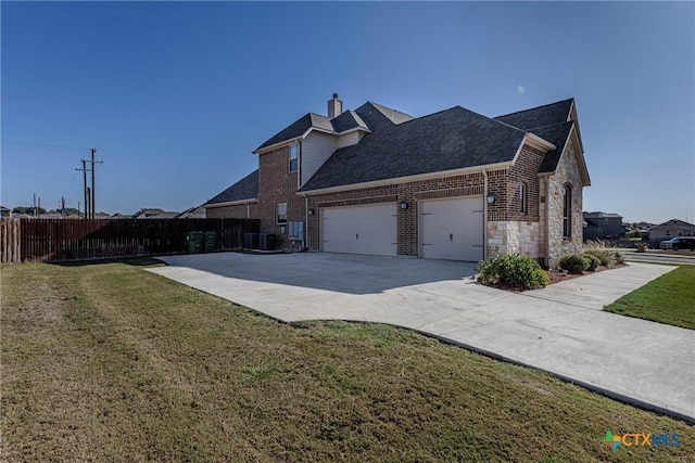 view of side of home featuring central AC and a yard