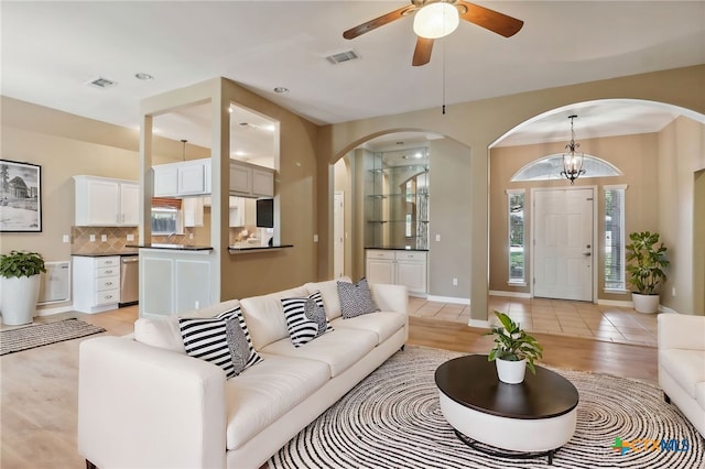 453 Raven Rdg, New Braunfels, TX 78130 - living room with arched walkways, ceiling fan, baseboards, and recessed lighting