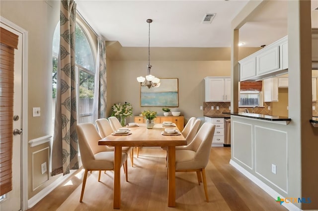 453 Raven Rdg, New Braunfels, TX 78130 - dining space with light wood-style flooring, a chandelier, and healthy amount of natural light