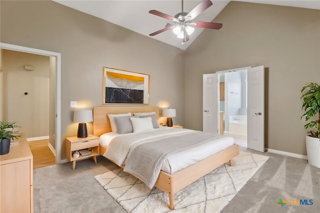 453 Raven Rdg, New Braunfels, TX 78130 - bedroom with high vaulted ceiling, light carpet, ensuite bath, baseboards, and ceiling fan