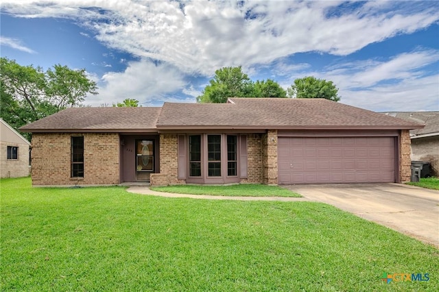 220 Briarmeadow Ln, Victoria, TX 77904 - ranch-style house featuring an attached garage, concrete driveway, a front lawn, brick siding, and a shingled roof
