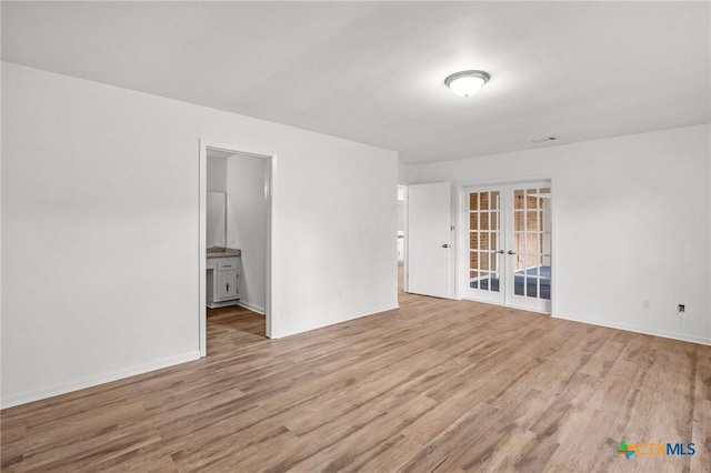 220 Briarmeadow Ln, Victoria, TX 77904 - empty room featuring french doors and light wood finished floors