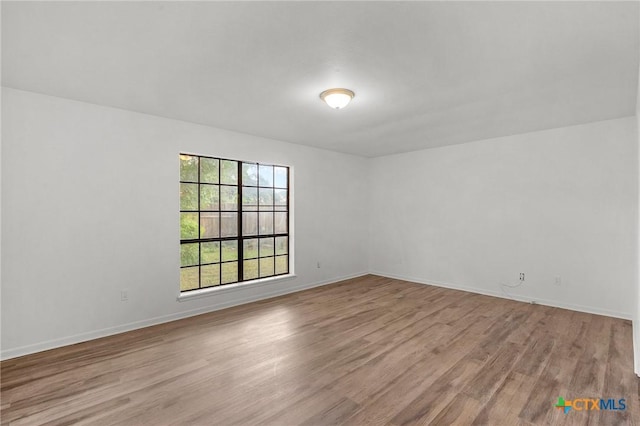 spare room with light wood-type flooring