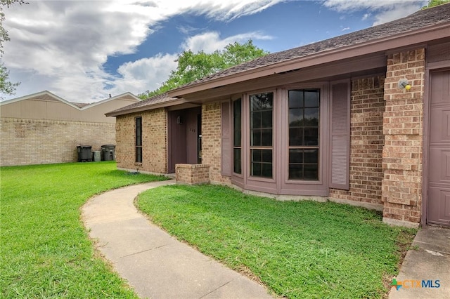 entrance to property with a lawn