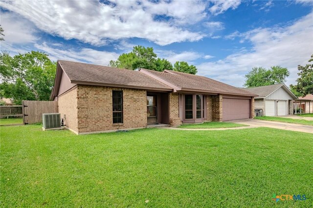 single story home featuring a front lawn, a garage, and cooling unit