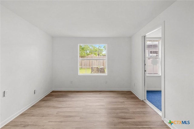 unfurnished room with light hardwood / wood-style flooring