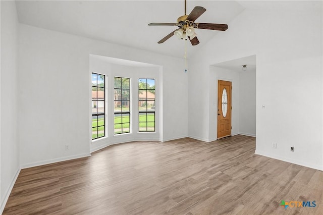 unfurnished room with light hardwood / wood-style floors, ceiling fan, and lofted ceiling