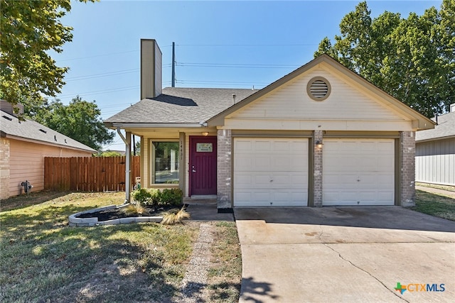 view of front of house with a front yard and a garage