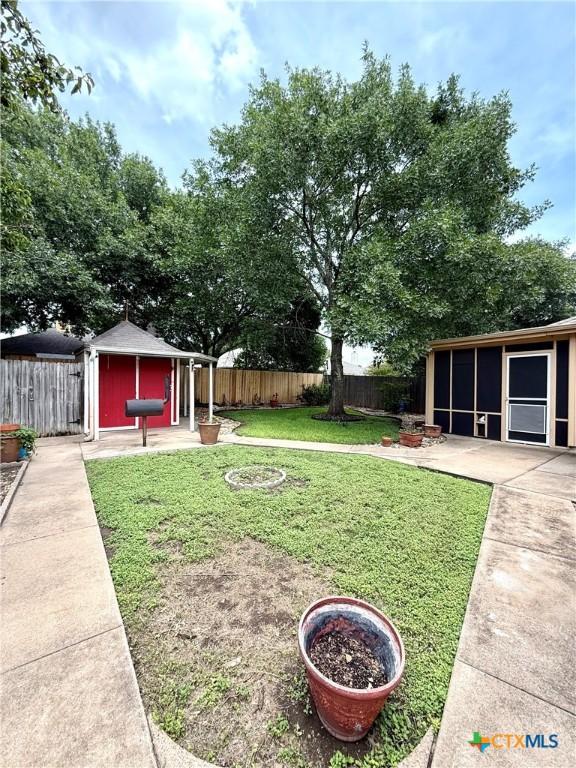1828 Winchester Dr, Temple, TX 76502 - fenced backyard featuring an outdoor structure