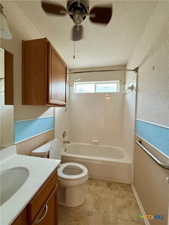 1828 Winchester Dr, Temple, TX 76502 - full bathroom with vanity,  shower combination, a textured wall, a textured ceiling, and ceiling fan