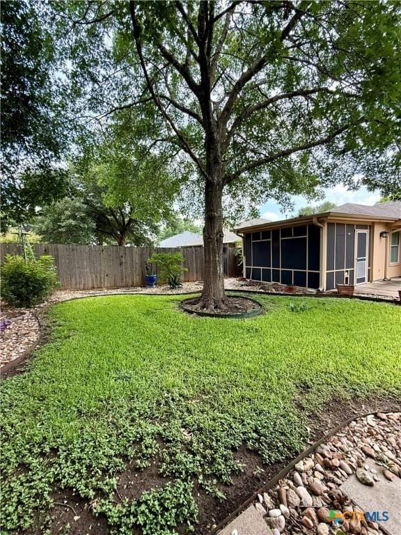 1828 Winchester Dr, Temple, TX 76502 - fenced backyard with a sunroom