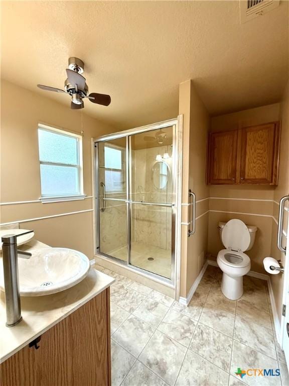 1828 Winchester Dr, Temple, TX 76502 - bathroom featuring a ceiling fan, a stall shower, vanity, tile patterned flooring, and a textured ceiling