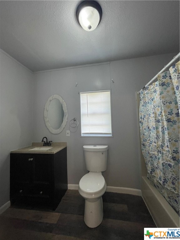 full bathroom with hardwood / wood-style floors, vanity, toilet, and a textured ceiling