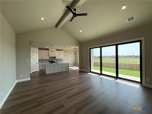 4015 Prairie Dr, Nolanville, TX 76559 - unfurnished living room with beam ceiling, a ceiling fan, dark wood-style flooring, baseboards, and a sink
