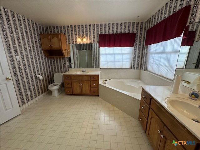 full bath with a sink, a bath, and wallpapered walls