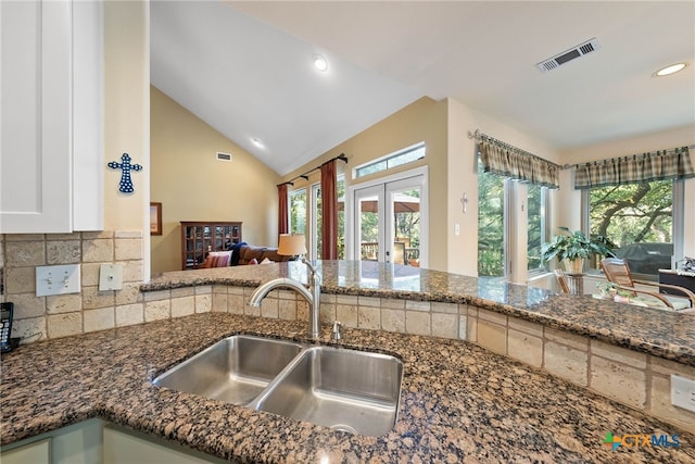 9063 Schoenthal Rd, San Antonio, TX 78266 - kitchen with dark stone counters, recessed lighting, french doors, tasteful backsplash, and open floor plan