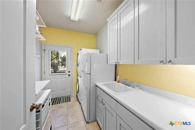 9063 Schoenthal Rd, San Antonio, TX 78266 - laundry room featuring cabinet space, light tile patterned floors, and washer / dryer