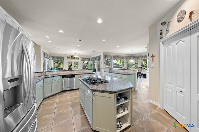 9063 Schoenthal Rd, San Antonio, TX 78266 - kitchen featuring stainless steel appliances, a center island, a peninsula, recessed lighting, and light tile patterned flooring