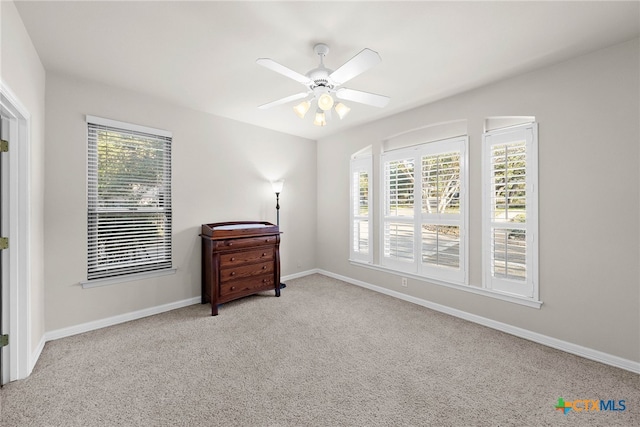 9063 Schoenthal Rd, San Antonio, TX 78266 - unfurnished bedroom featuring multiple windows, carpet, and a ceiling fan