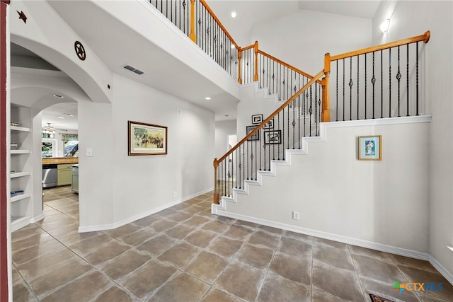 9063 Schoenthal Rd, San Antonio, TX 78266 - stairs with high vaulted ceiling and baseboards