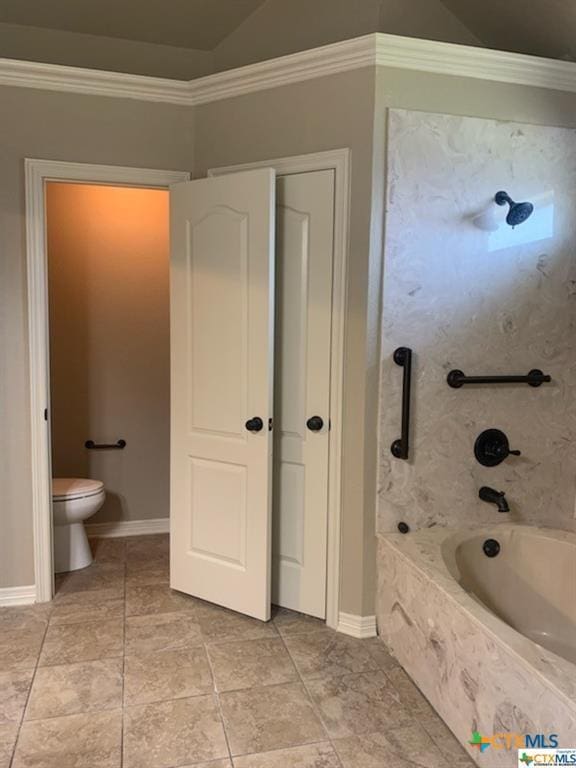 bathroom with toilet, tile patterned flooring, tiled shower / bath combo, and ornamental molding