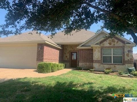 single story home with a garage and a front lawn