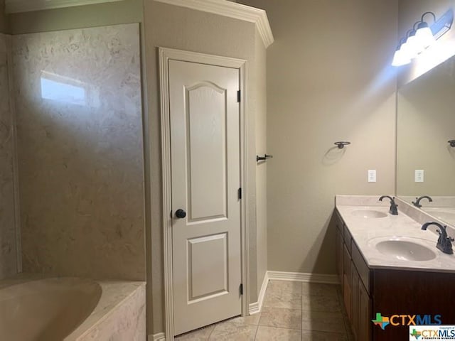 bathroom with tile patterned flooring, vanity, a relaxing tiled tub, and crown molding