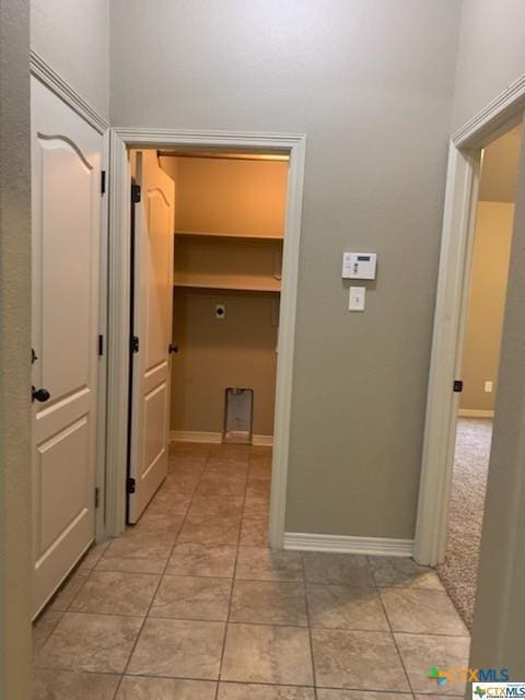 corridor featuring light tile patterned floors