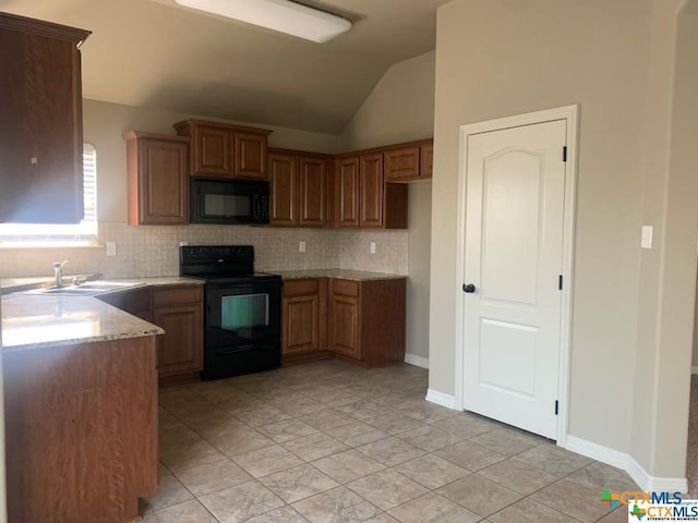 kitchen featuring light stone countertops, backsplash, sink, black appliances, and lofted ceiling