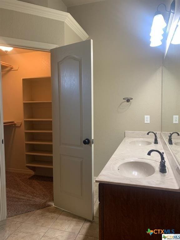 bathroom with tile patterned floors, vanity, and ornamental molding