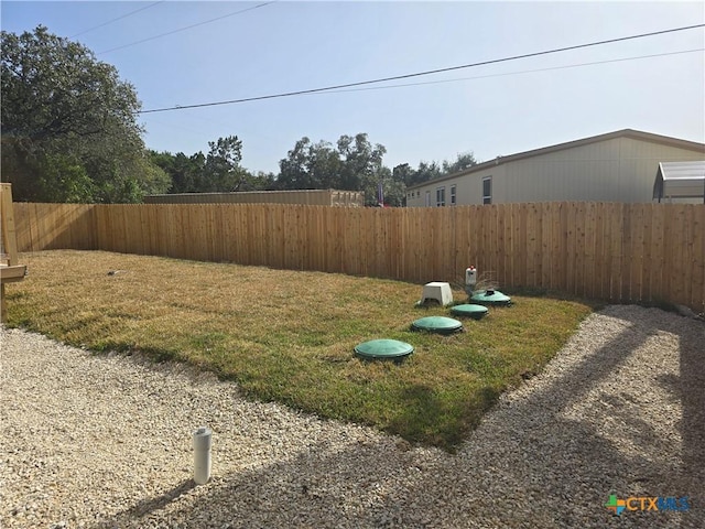 view of yard with a fenced backyard