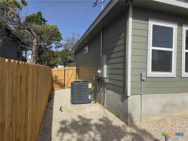 view of home's exterior featuring central AC and fence