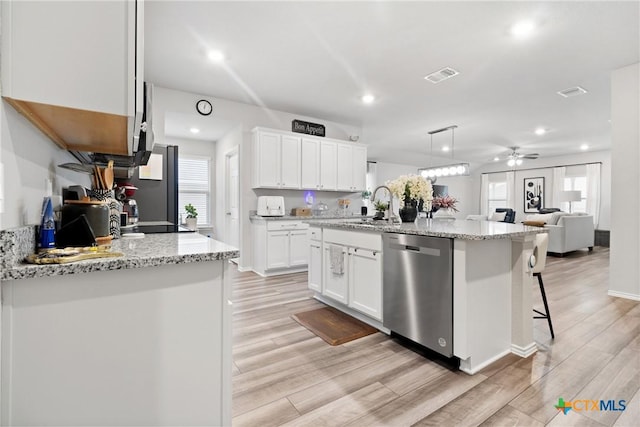 kitchen with white cabinetry, decorative light fixtures, light wood-type flooring, appliances with stainless steel finishes, and an island with sink