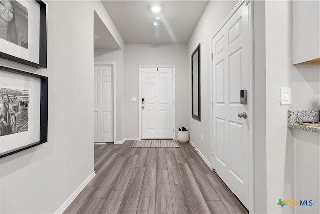 corridor with hardwood / wood-style floors