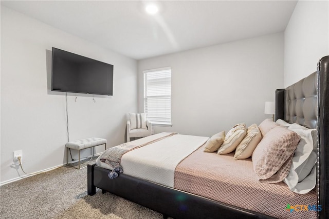 carpeted bedroom featuring baseboards