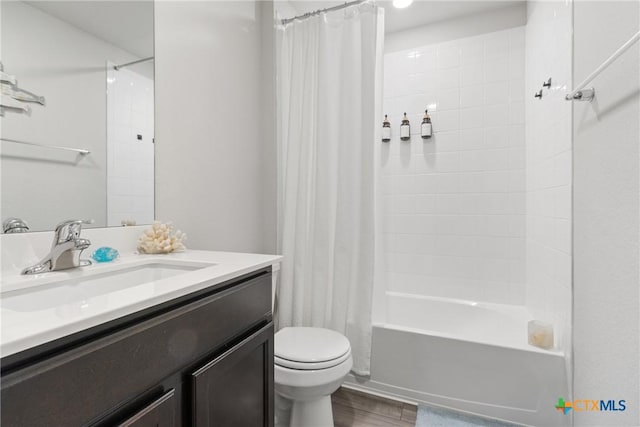 full bathroom with vanity, wood-type flooring, toilet, and shower / bath combo