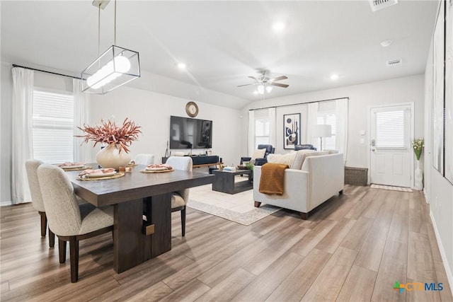 dining space with light hardwood / wood-style floors and ceiling fan