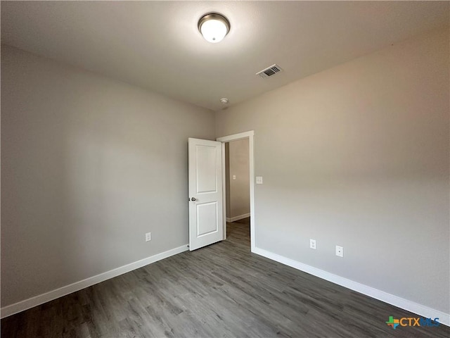 unfurnished room with hardwood / wood-style flooring