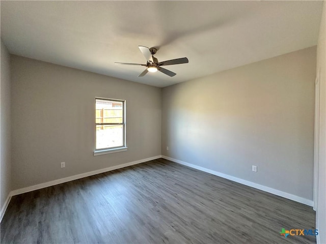 spare room featuring ceiling fan and dark hardwood / wood-style flooring