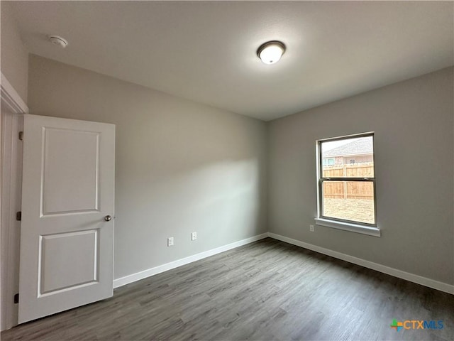 unfurnished room featuring hardwood / wood-style flooring