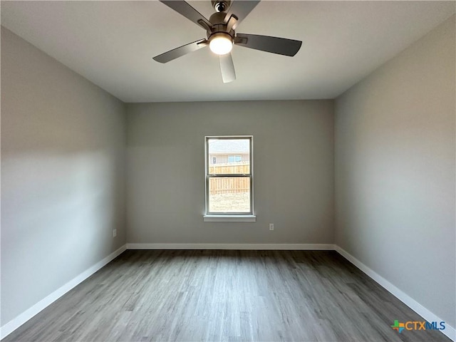 spare room with ceiling fan and wood-type flooring