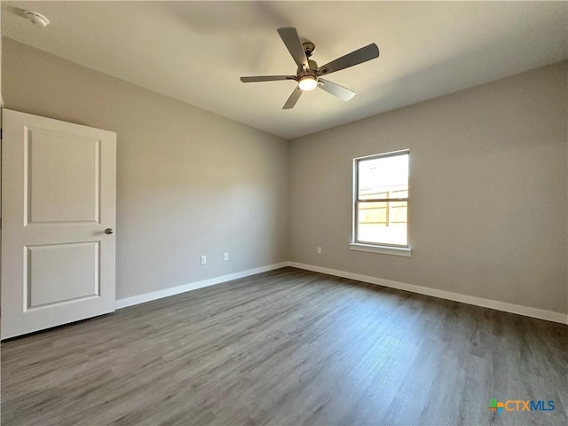 empty room featuring hardwood / wood-style flooring and ceiling fan